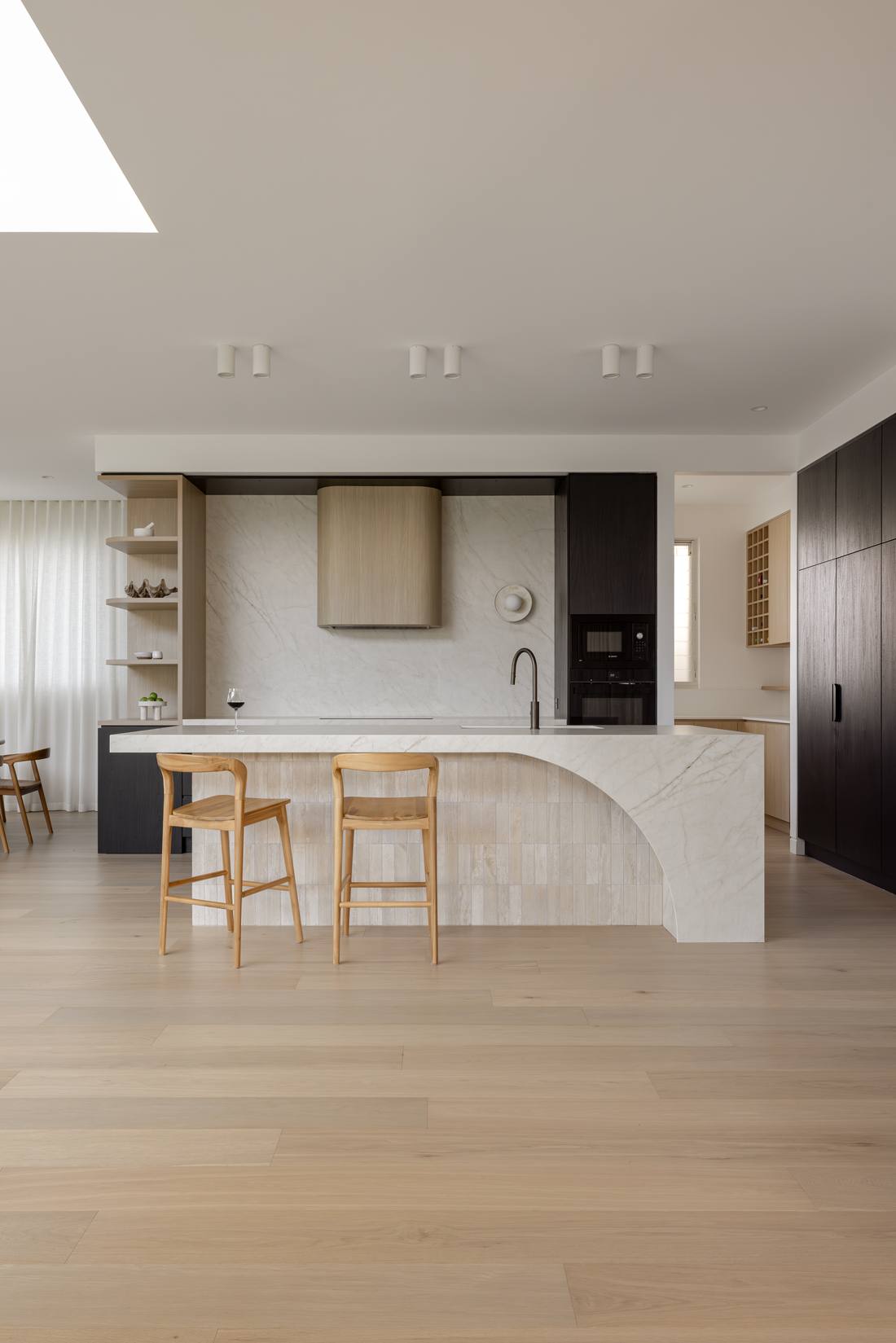 Kitchen island in travertine and oak over engineered oak timber flooring